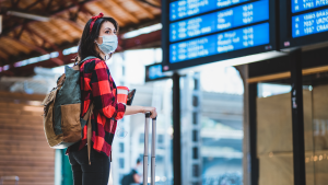asian-woman-sitting-window-holding-mobile-view-airport